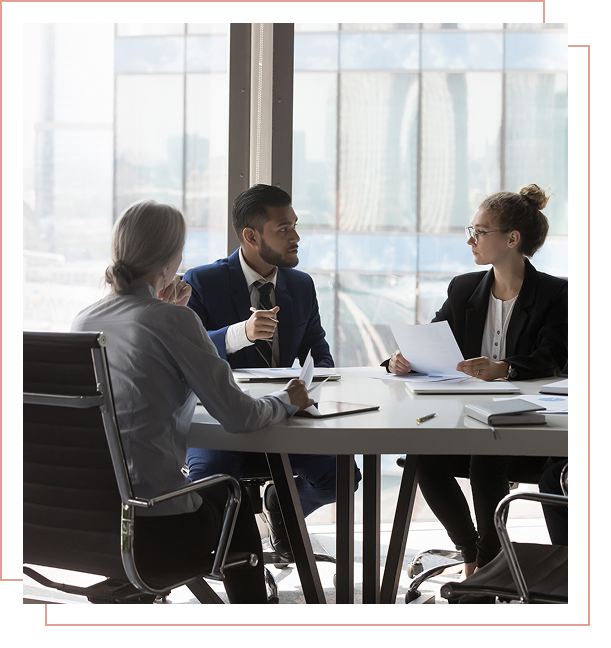 Business meeting with three professionals conversing.