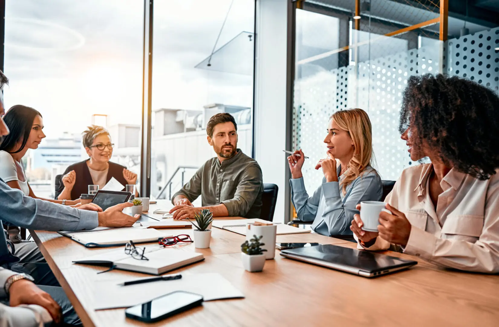 People in a meeting at a table.